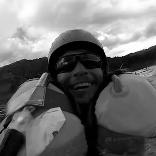 Karlis Jaunpetrovičs practicing paragliding acrobatic maneuvers over water, SIV training origins.